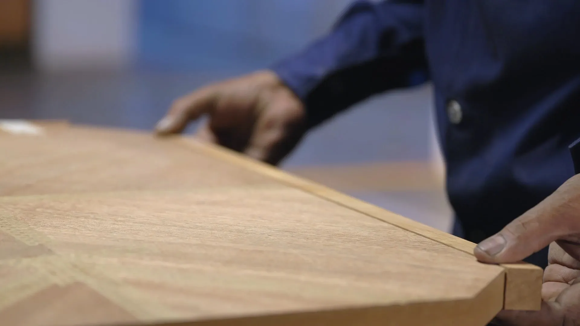 Craftsman checking the edge of a plank