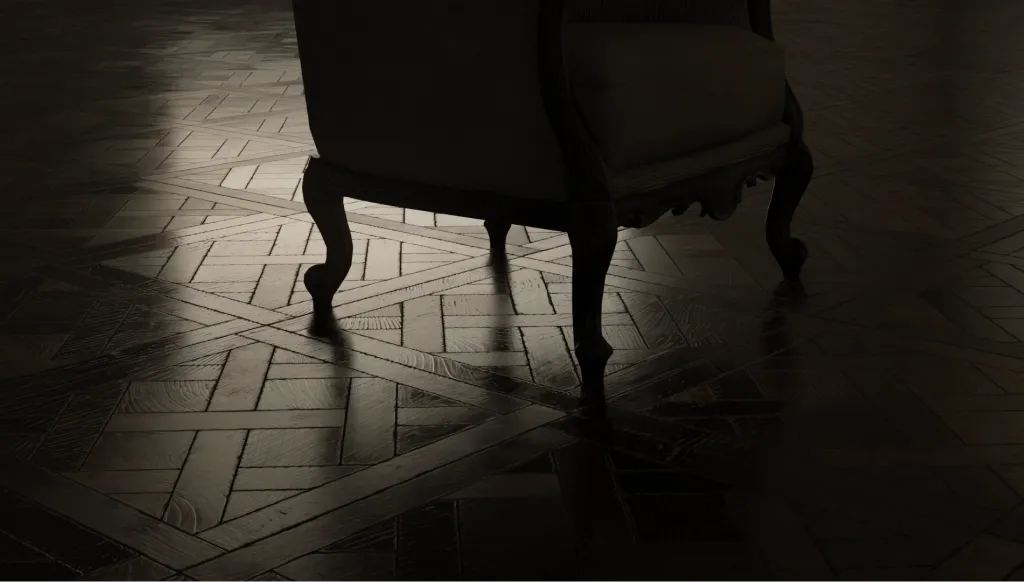 Armchair on a solid wood parquet floor in low light