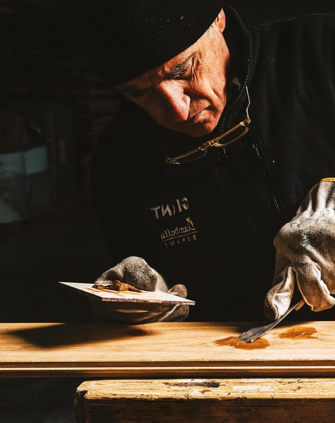 Craftsman finishing a plank by hand